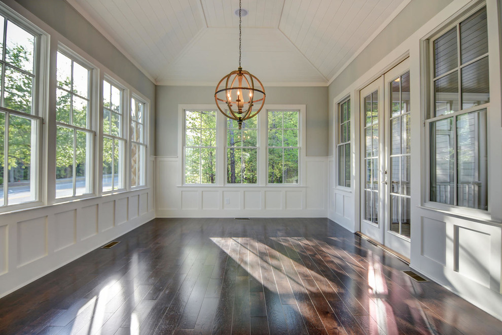 This is an example of a traditional conservatory in Other with dark hardwood flooring.
