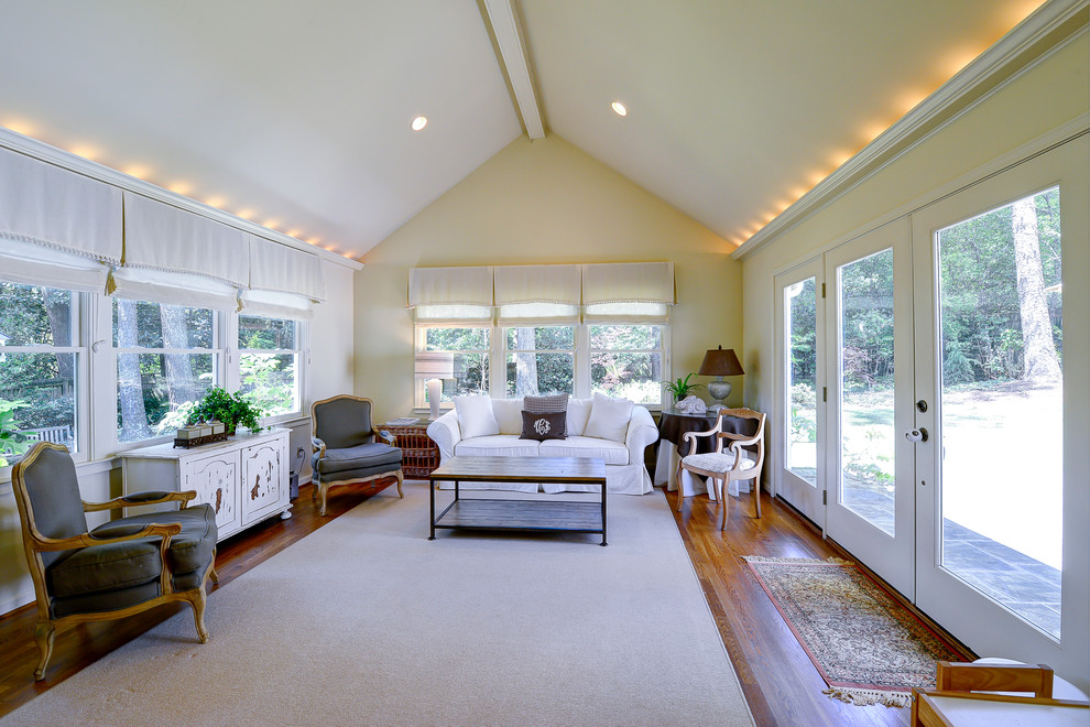 Large shabby-chic style conservatory in Atlanta with medium hardwood flooring, a standard ceiling and brown floors.