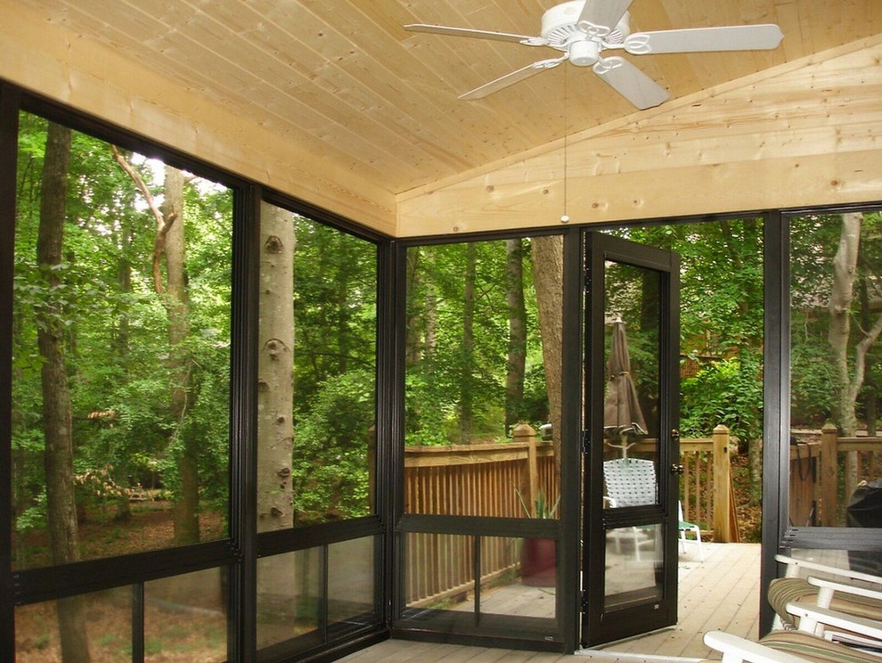 Medium sized rustic conservatory in Philadelphia with dark hardwood flooring and a standard ceiling.