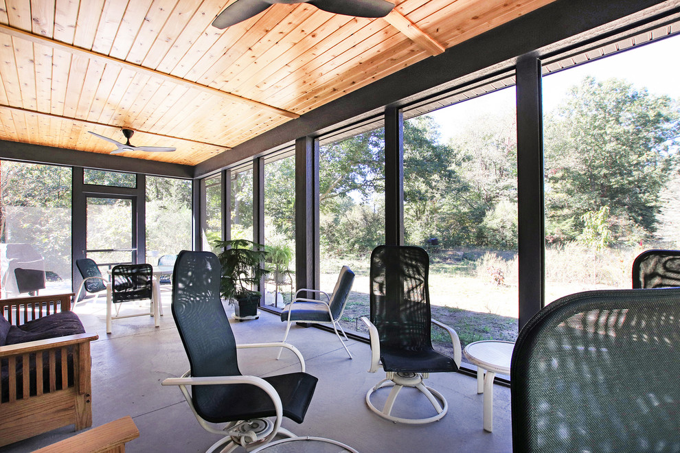 Immagine di una grande veranda moderna con pavimento in cemento, soffitto classico e pavimento grigio