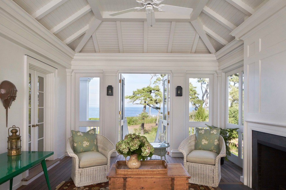 Inspiration for a mid-sized coastal dark wood floor sunroom remodel in Boston with a standard fireplace, a stone fireplace and a standard ceiling