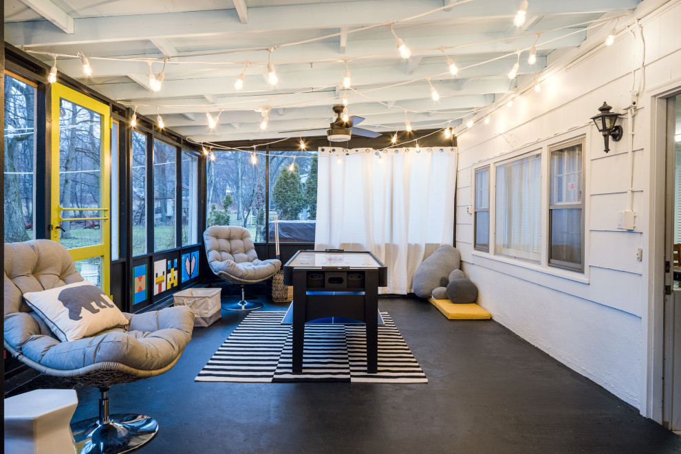Idee per una veranda rustica di medie dimensioni con pavimento in cemento, soffitto classico e pavimento nero