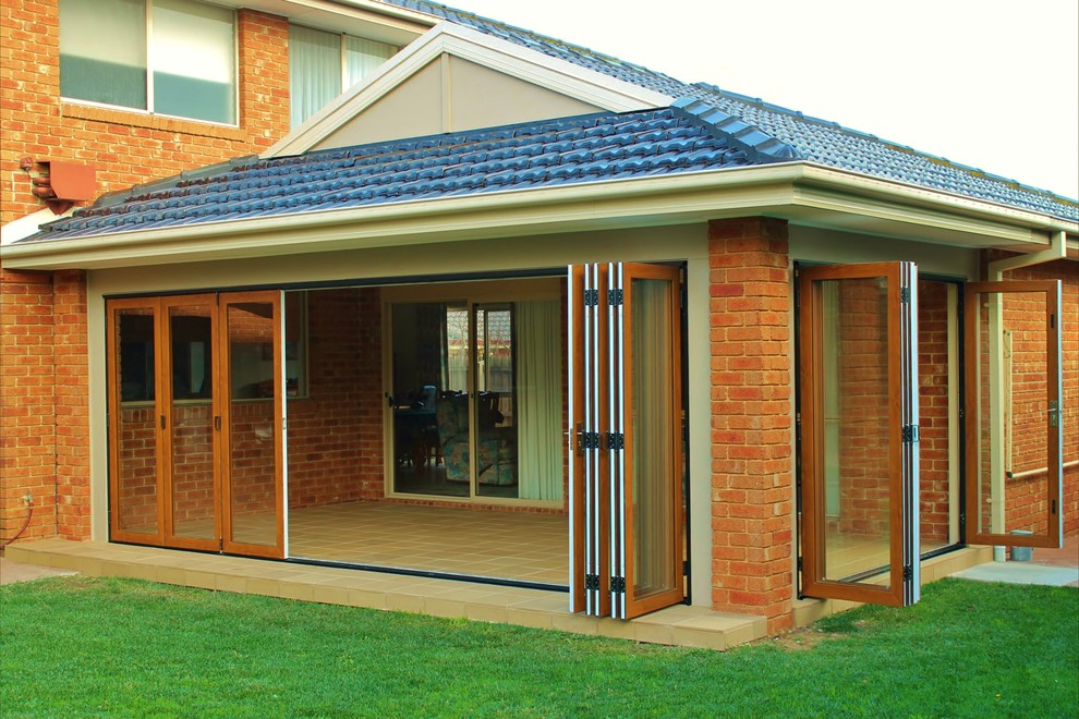 This is an example of a classic conservatory in Melbourne with porcelain flooring and a standard ceiling.