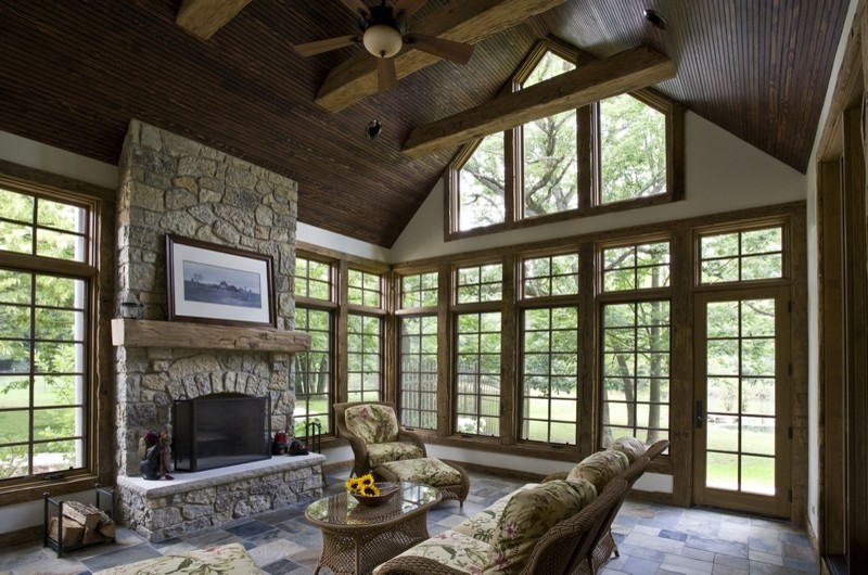 Example of a huge classic slate floor sunroom design in Chicago with a standard fireplace and a stone fireplace