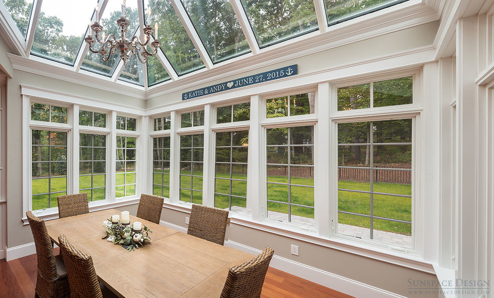 Medium sized classic conservatory in Boston with dark hardwood flooring, no fireplace and a glass ceiling.