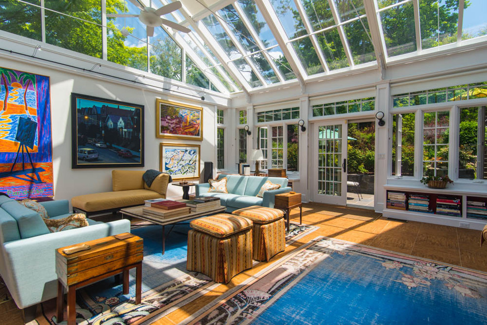 Photo of a classic conservatory in New York with medium hardwood flooring and a glass ceiling.