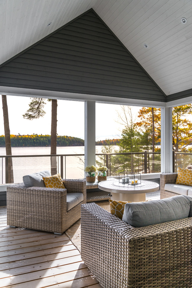 Photo of a beach style conservatory in Toronto with medium hardwood flooring, a standard ceiling and beige floors.