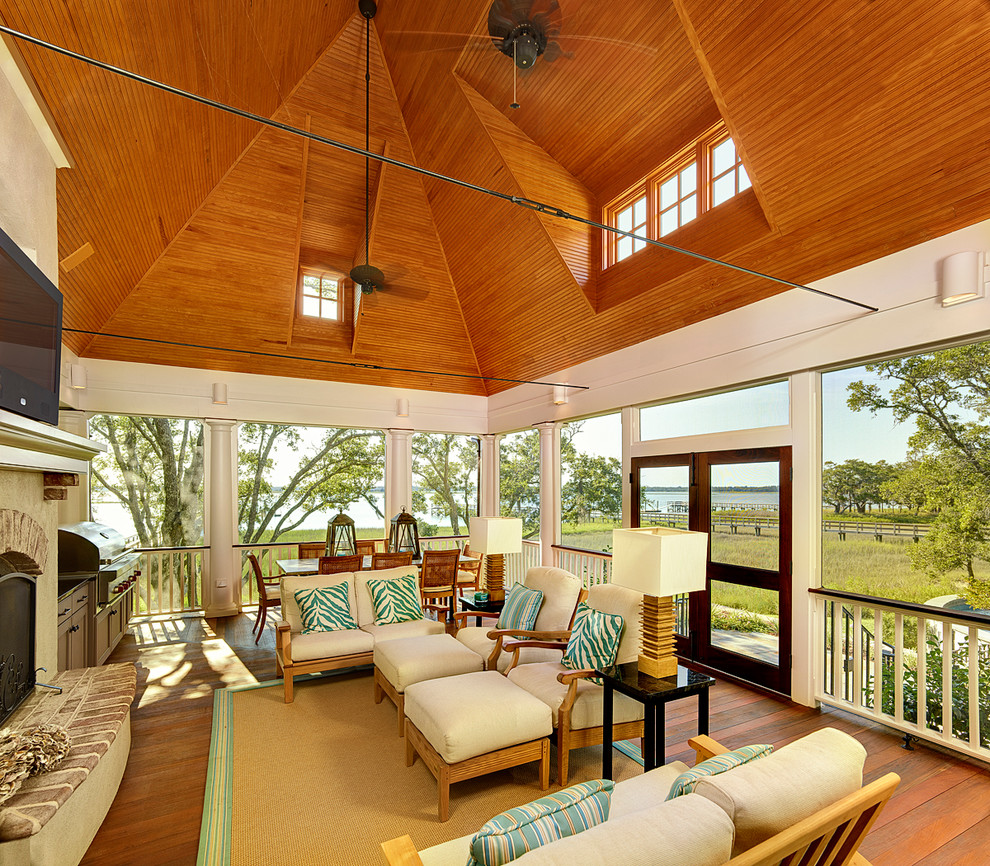 Inspiration for a timeless medium tone wood floor sunroom remodel in Charleston with a standard ceiling
