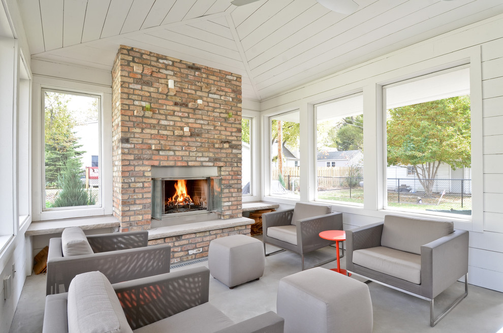 Country concrete floor and gray floor sunroom photo in Minneapolis with a brick fireplace and a standard ceiling