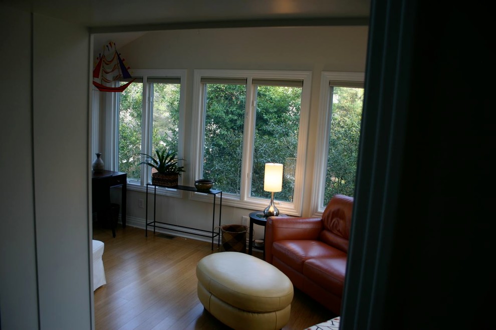 This is an example of a contemporary conservatory in Raleigh with bamboo flooring.