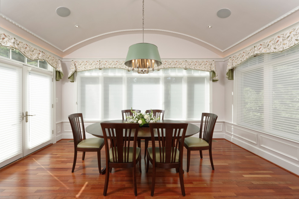 Example of a transitional medium tone wood floor and brown floor dining room design in DC Metro