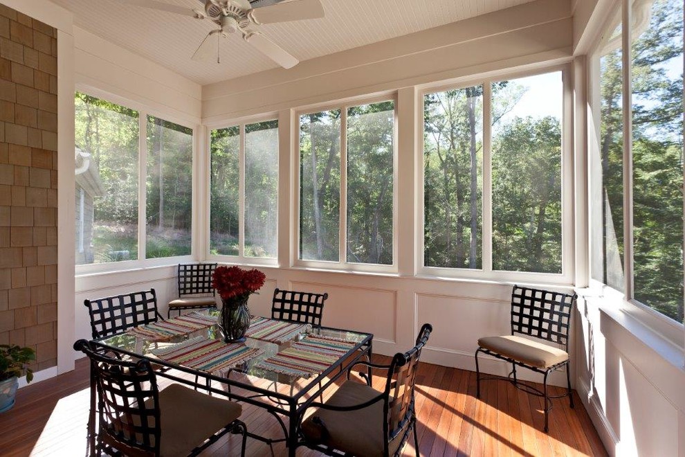 Medium sized traditional conservatory in Huntington with dark hardwood flooring, a standard ceiling and brown floors.