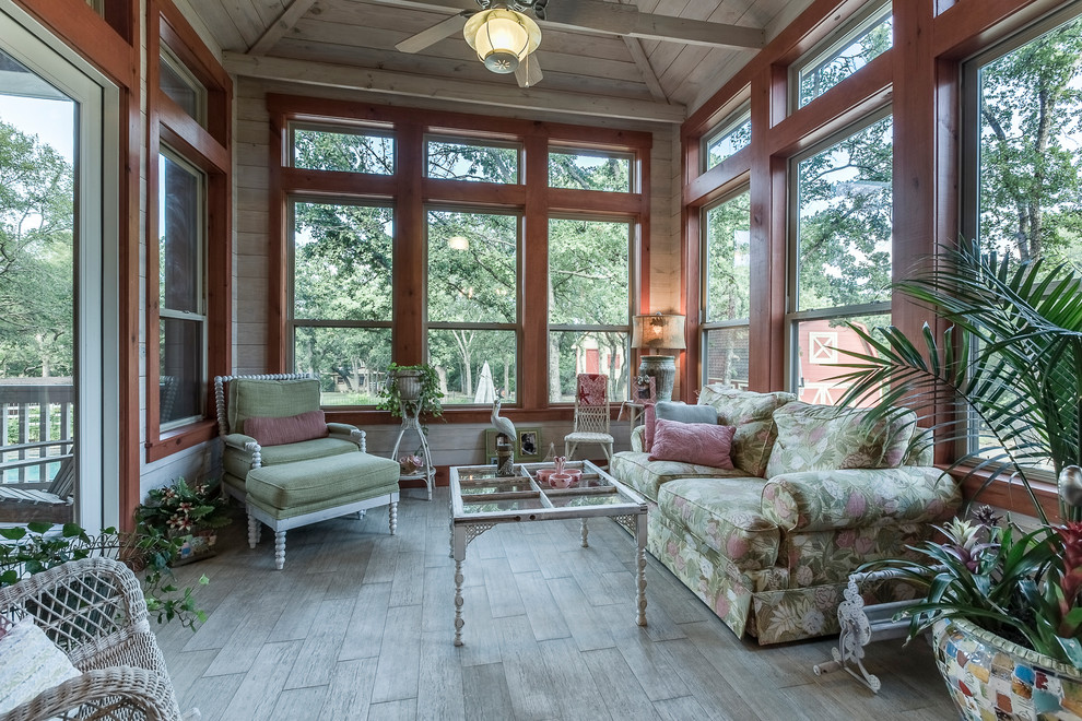 This is an example of a large classic conservatory in Dallas with light hardwood flooring and a standard ceiling.