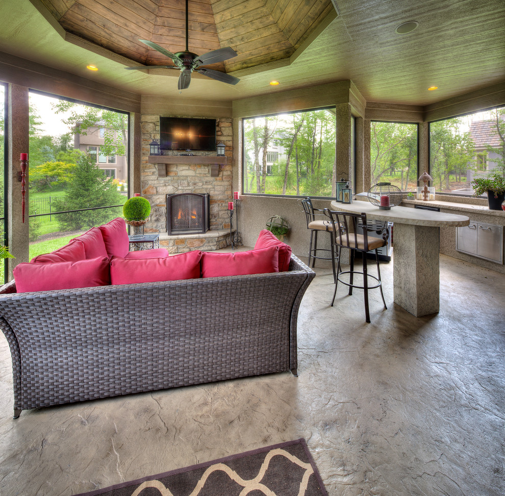 Inspiration for a mediterranean concrete floor and gray floor sunroom remodel in Kansas City with a stone fireplace and a standard ceiling