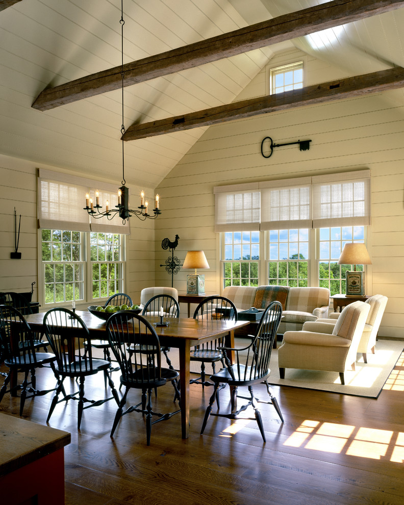 Immagine di un'ampia veranda country con pavimento in legno massello medio e soffitto classico