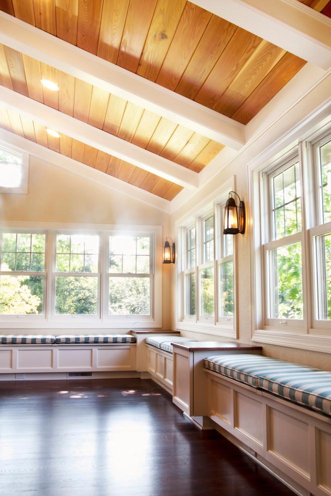 Large traditional conservatory in Milwaukee with dark hardwood flooring, a standard fireplace and a standard ceiling.
