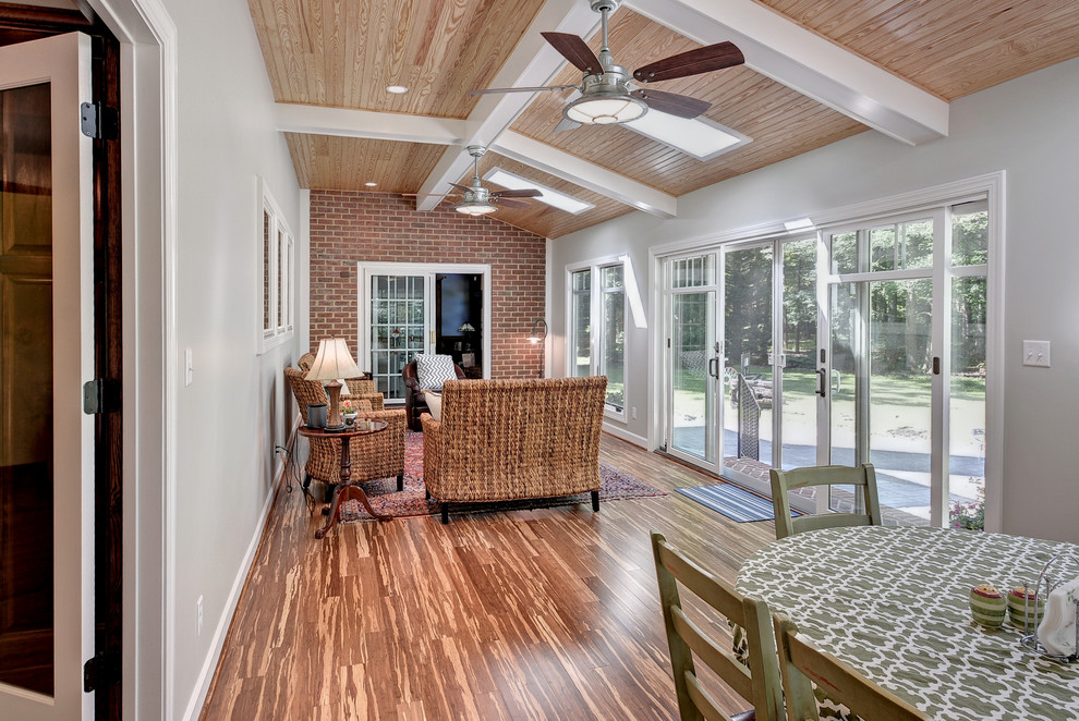Foto di una grande veranda tradizionale con pavimento in legno massello medio, nessun camino, lucernario e pavimento marrone