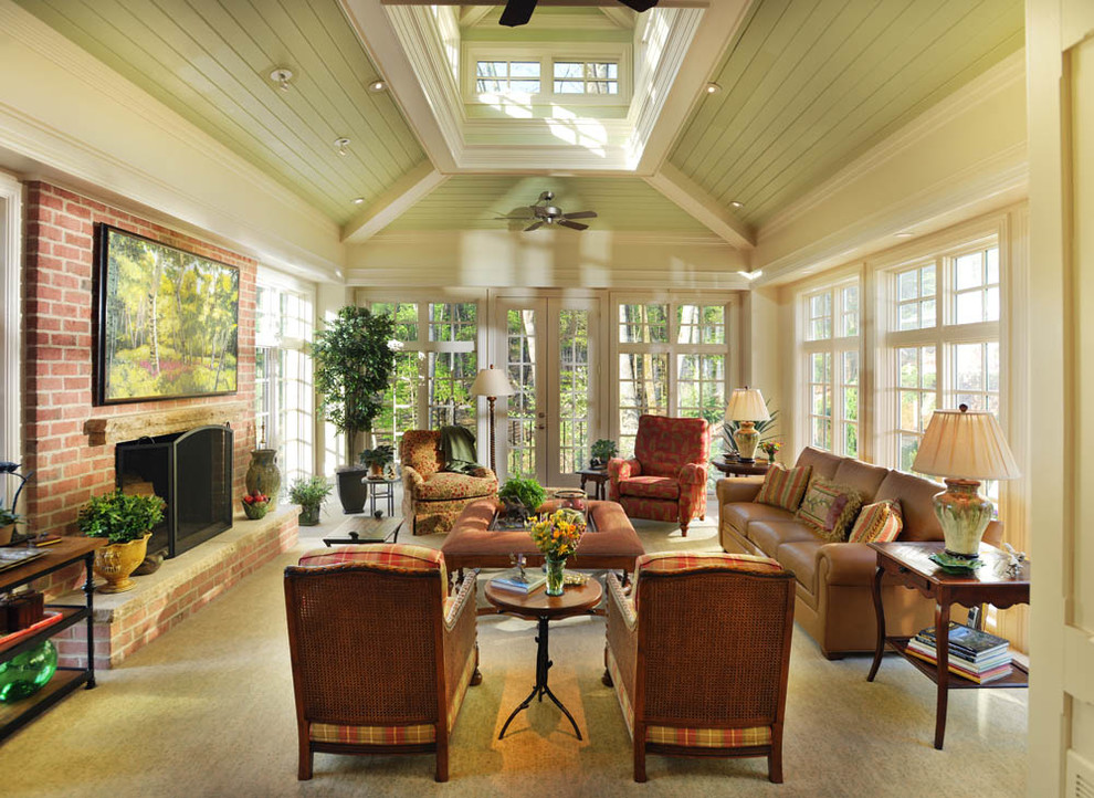 Elegant sunroom photo in Nashville with a brick fireplace and a skylight