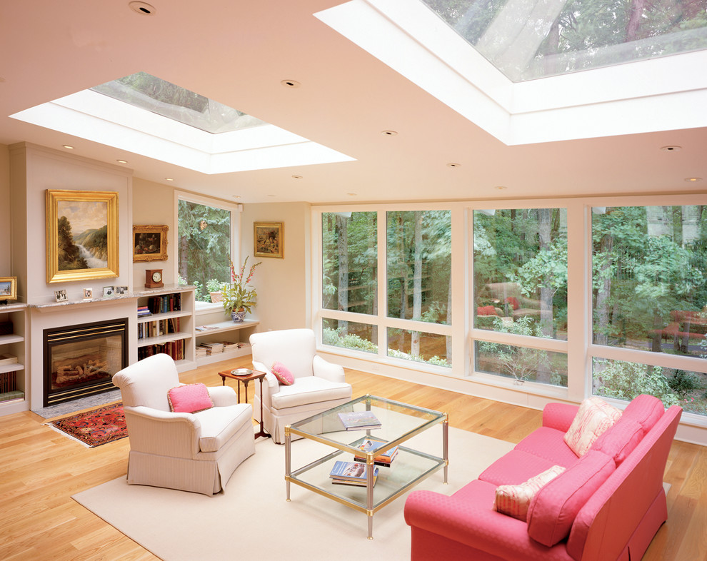 Huge trendy light wood floor sunroom photo in Philadelphia with a wood fireplace surround and a skylight