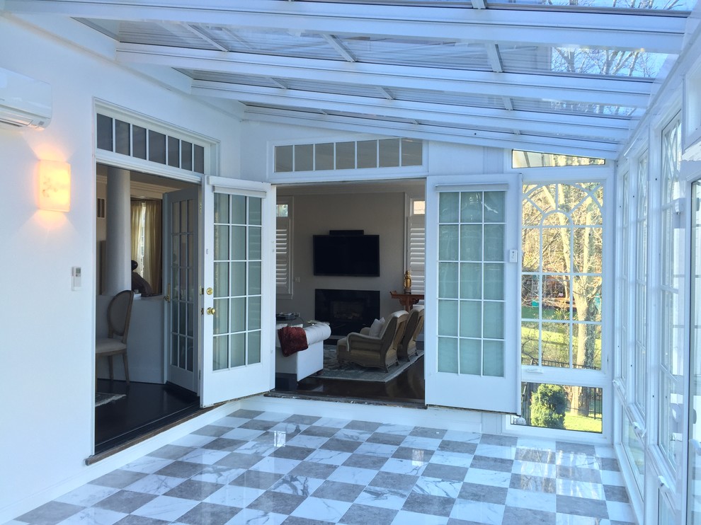 Large elegant ceramic tile sunroom photo in Boston with a hanging fireplace, a glass ceiling and a metal fireplace