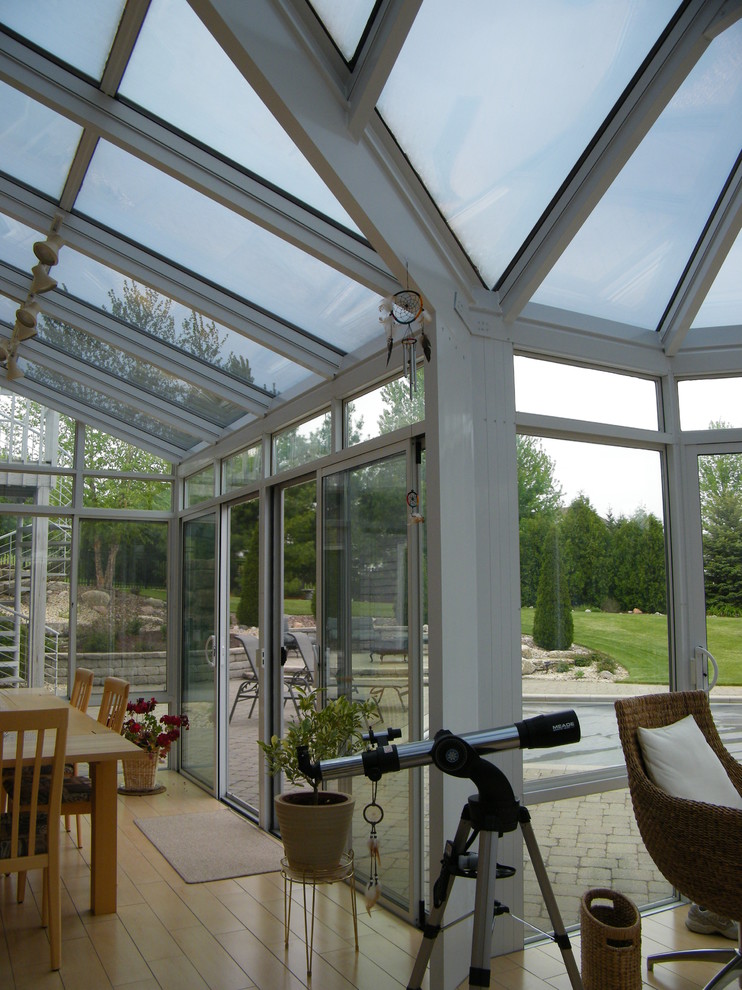 Photo of a medium sized contemporary conservatory in Other with a glass ceiling, light hardwood flooring and no fireplace.