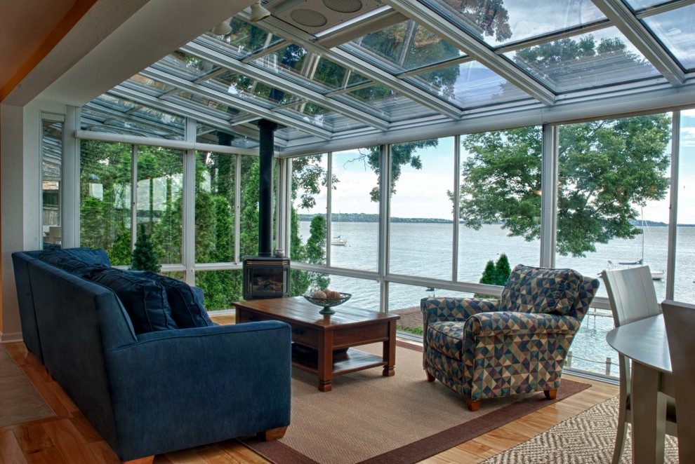 This is an example of a medium sized classic conservatory in Other with no fireplace and a glass ceiling.