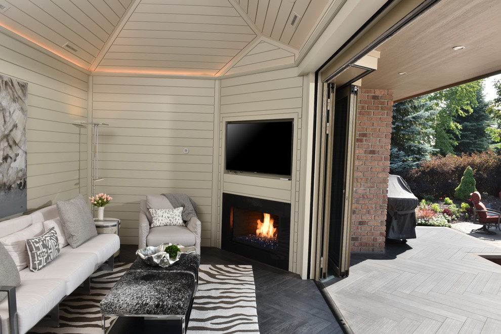 Inspiration for a conservatory in Other with a corner fireplace, a wooden fireplace surround, a standard ceiling and grey floors.
