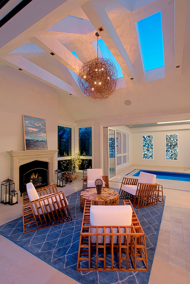 Photo of a large traditional conservatory in Chicago with travertine flooring, a standard fireplace, a stone fireplace surround, a skylight, beige floors and feature lighting.
