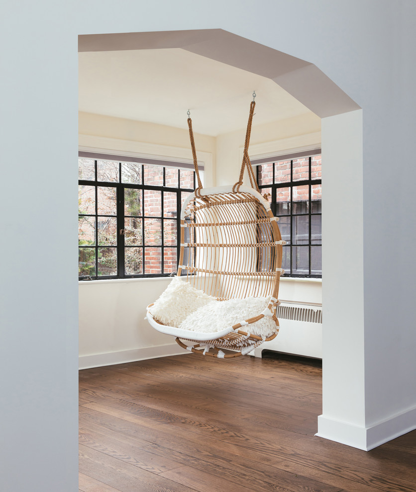 Design ideas for a modern conservatory in New York with dark hardwood flooring.