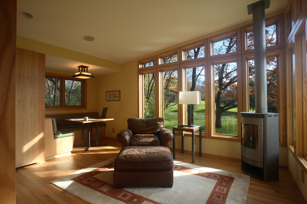 Inspiration for a large classic conservatory in Minneapolis with light hardwood flooring and a corner fireplace.
