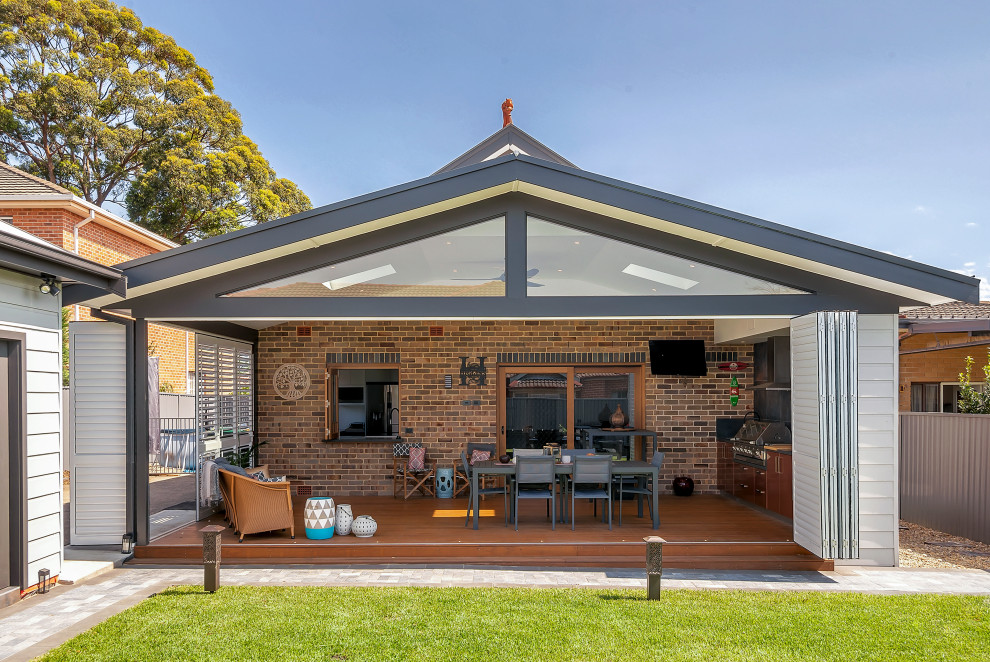 Medium sized contemporary conservatory in Sydney with dark hardwood flooring, a skylight and brown floors.