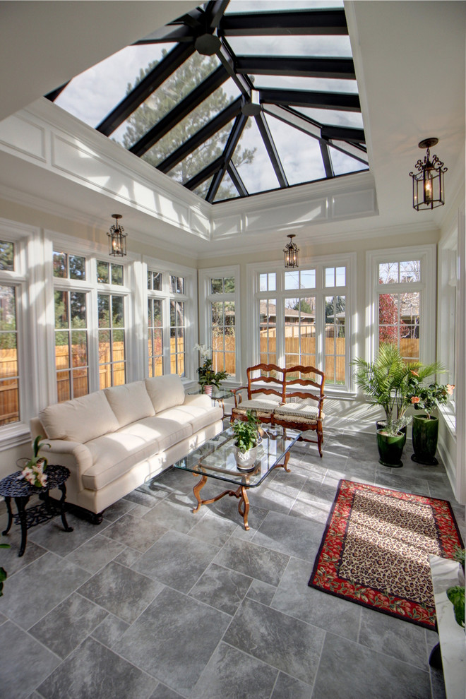 Large classic conservatory in Denver with ceramic flooring, a skylight and grey floors.