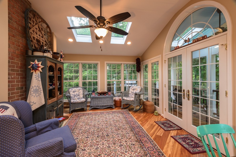 Inspiration for a traditional conservatory in DC Metro with dark hardwood flooring, no fireplace and a skylight.