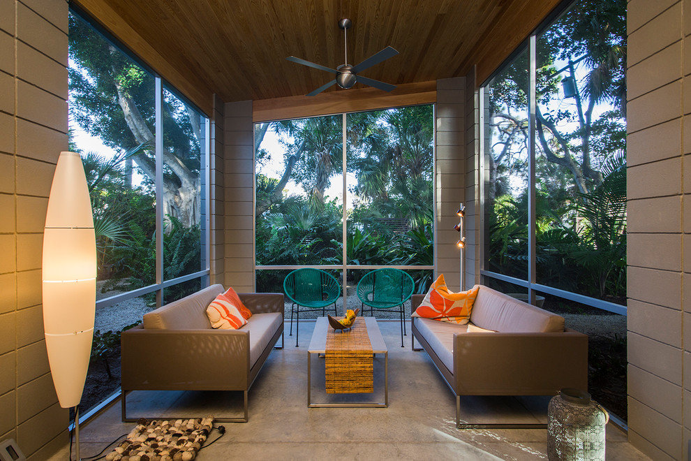 Inspiration for a retro conservatory in Tampa with concrete flooring, a standard ceiling and grey floors.