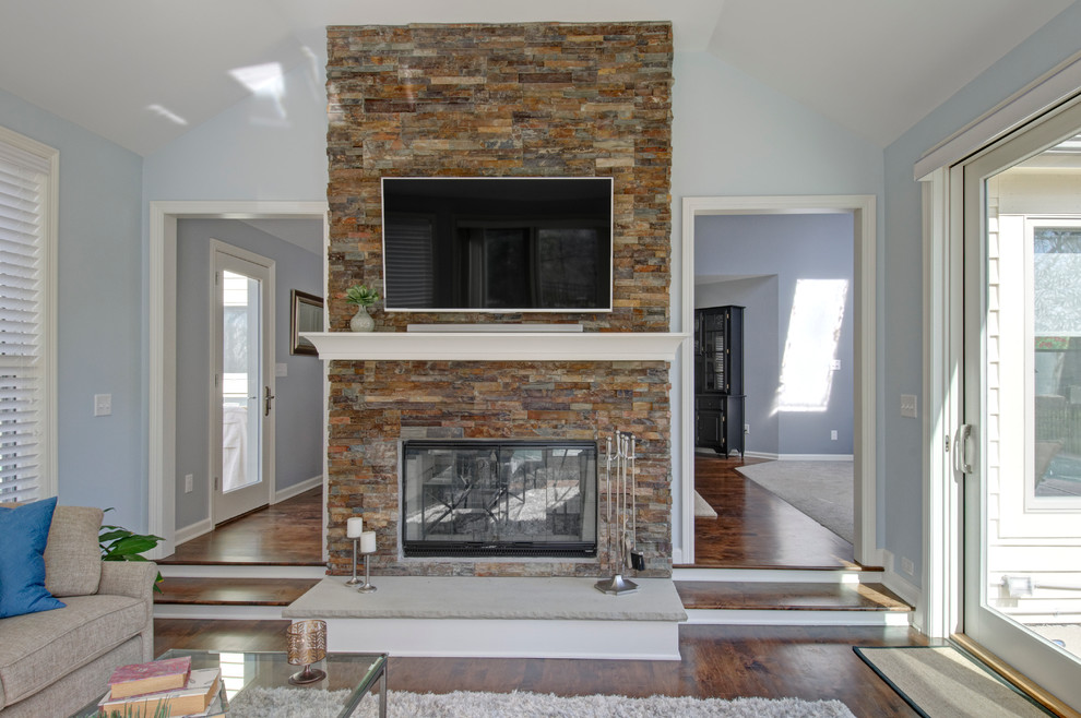 Sunroom - traditional dark wood floor sunroom idea in Columbus with a two-sided fireplace and a stone fireplace