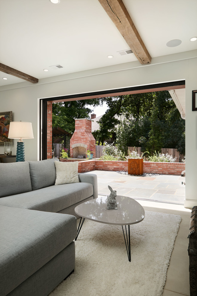 Ispirazione per una grande veranda chic con pavimento in cemento, camino classico, soffitto classico e pavimento bianco