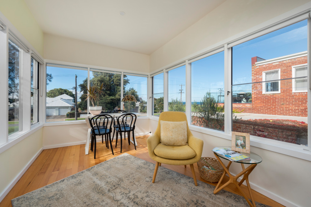 Mid-sized trendy medium tone wood floor and brown floor sunroom photo in Melbourne with no fireplace