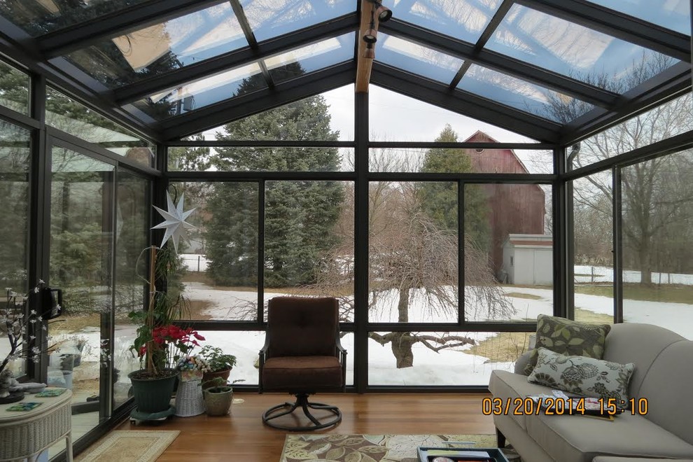 Example of a large classic light wood floor and beige floor sunroom design in Detroit with no fireplace and a skylight