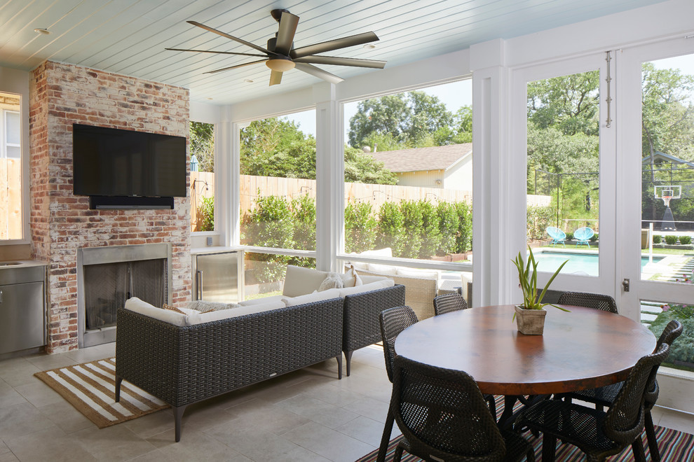 This is an example of a large country conservatory in Austin with ceramic flooring, a standard fireplace, a brick fireplace surround, beige floors and a standard ceiling.