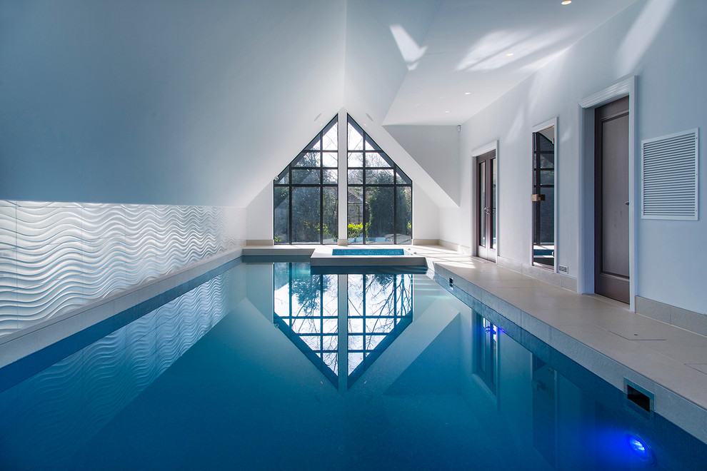 This is an example of a large contemporary indoor rectangular swimming pool in Cheshire with tiled flooring.