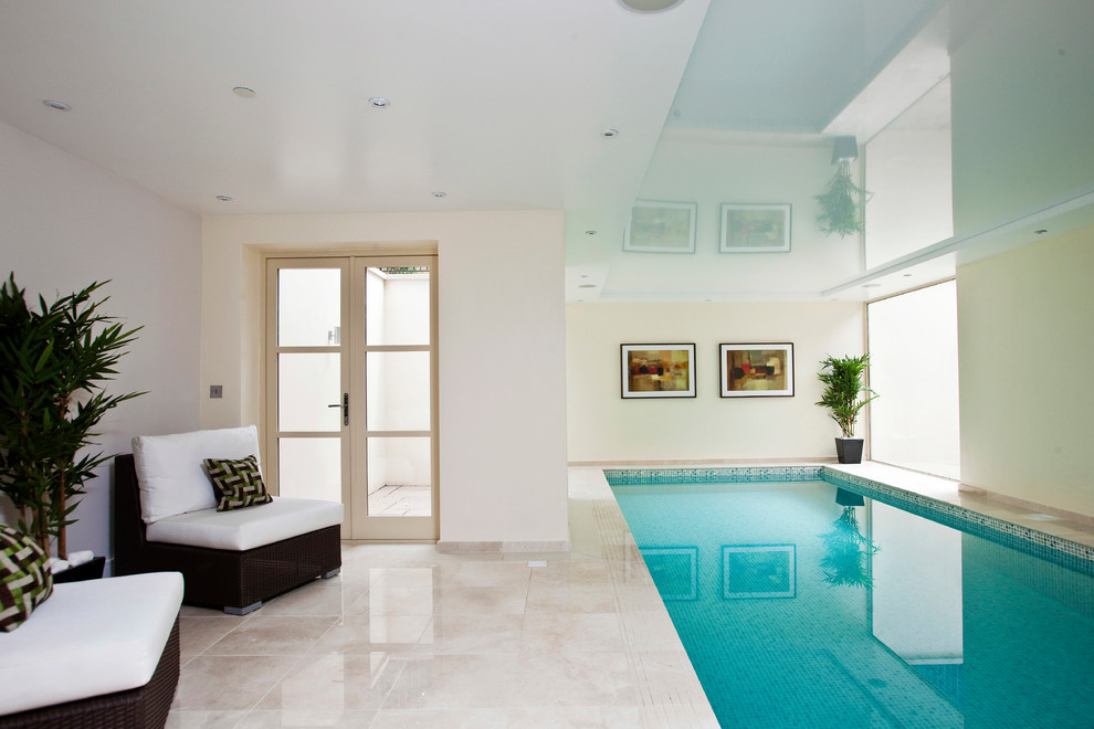 Design ideas for a contemporary indoor rectangular swimming pool in Surrey with tiled flooring.