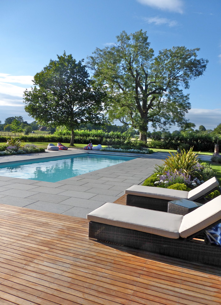 Contemporary swimming pool in London with stamped concrete.