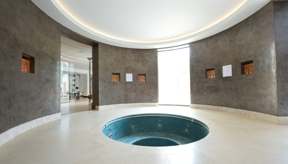Photo of a large contemporary indoor round hot tub in Other.