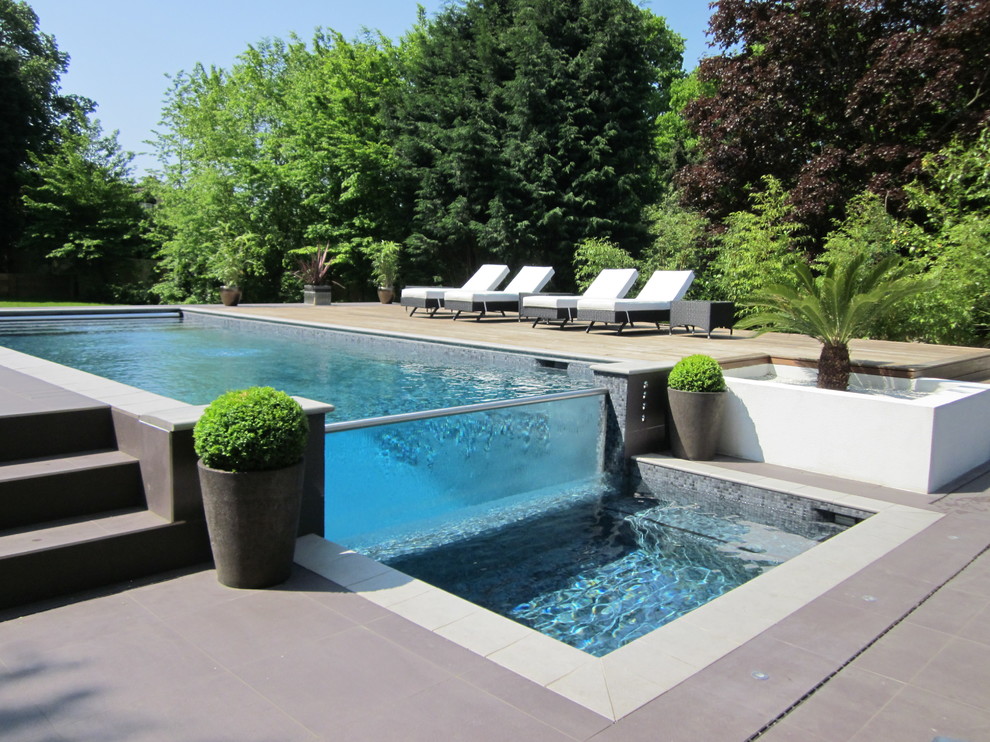 Design ideas for a contemporary rectangular swimming pool in Surrey.