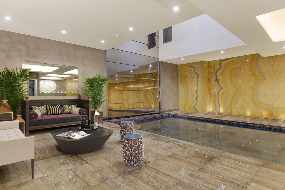 Large contemporary indoor rectangular lengths swimming pool in London with tiled flooring.