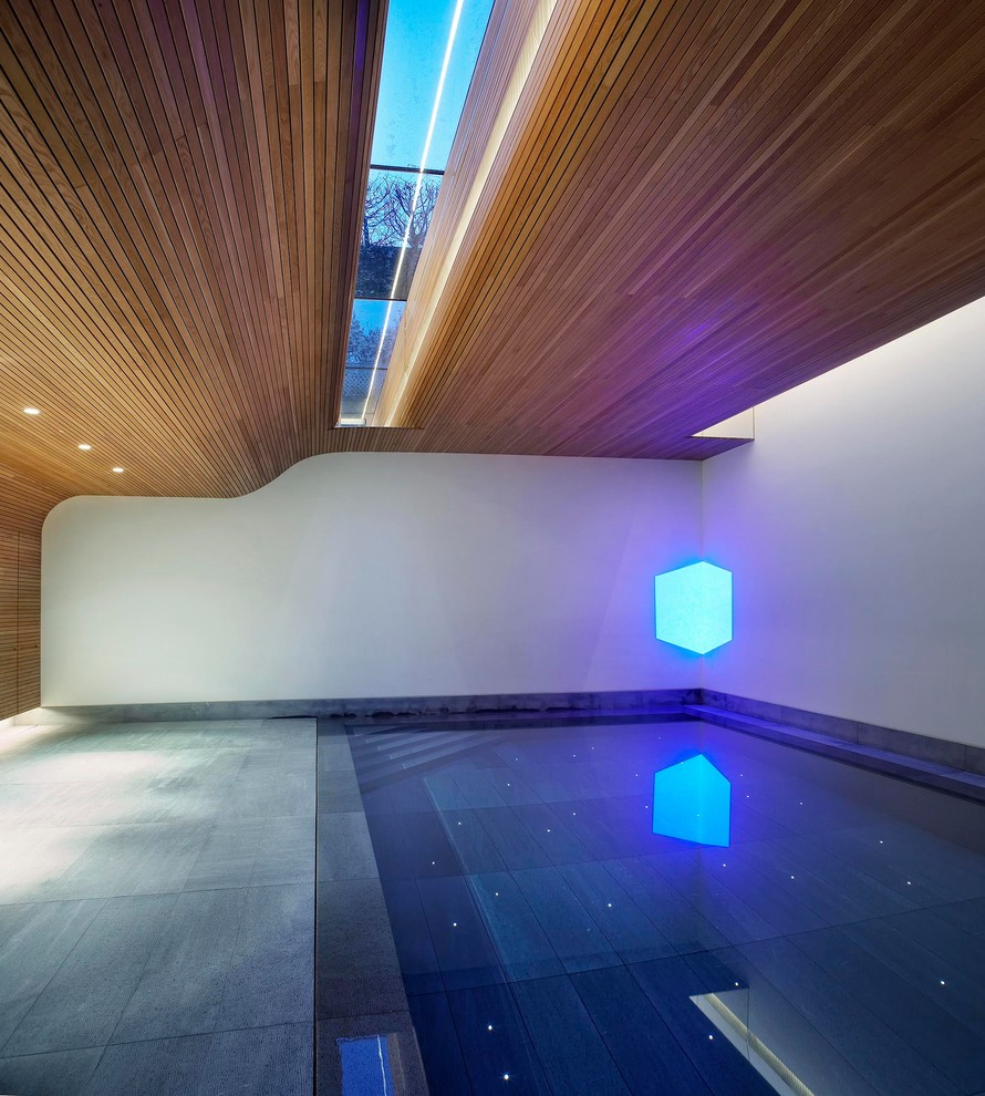 Design ideas for a large contemporary indoor rectangular swimming pool in London.