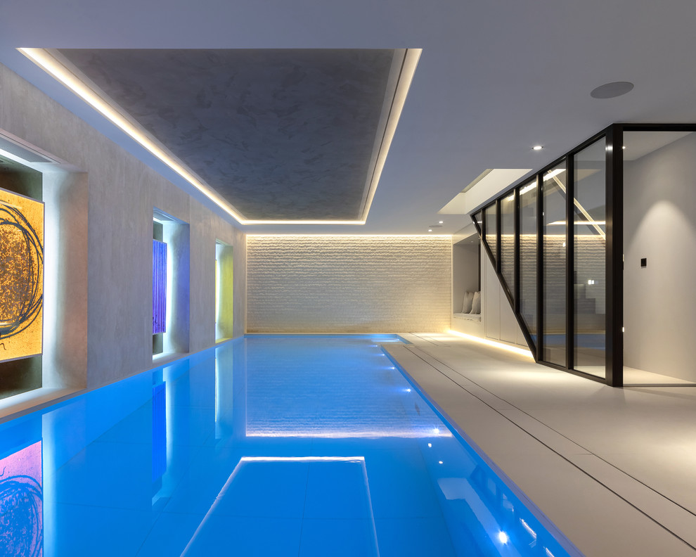 Design ideas for a contemporary indoor rectangular lengths swimming pool in London.
