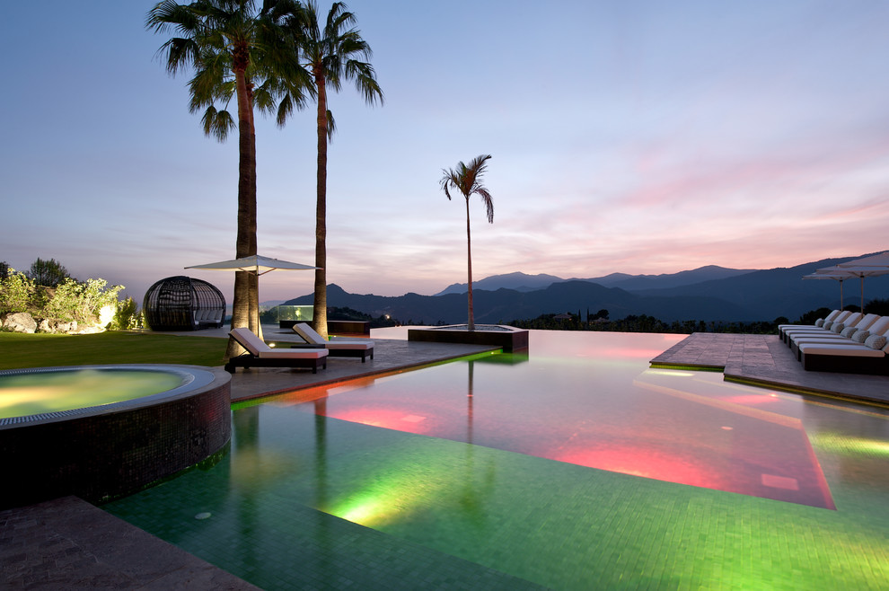 Hot tub - large contemporary custom-shaped infinity hot tub idea in Surrey
