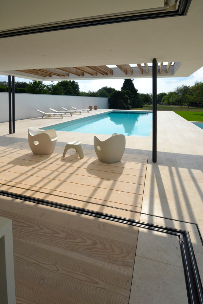 Inspiration for a contemporary swimming pool in London with concrete slabs.