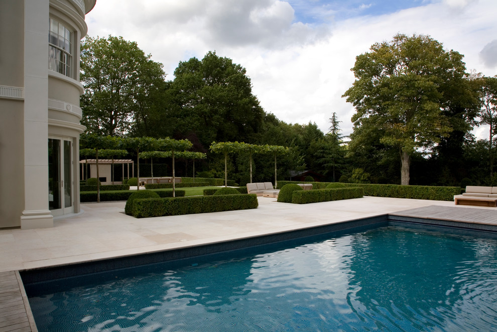 Medium sized contemporary back rectangular above ground swimming pool in Surrey.